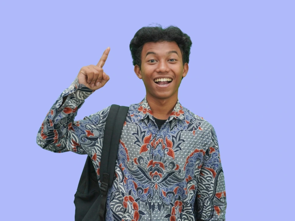 A man with a backpack giving a peace sign